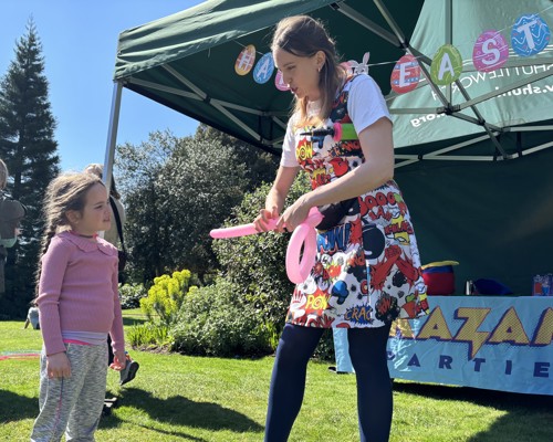 Child Talking To Balloon Modeller. Easter Bunny Flies In 2025. © The Shuttleworth Trust. Photo Hannah Hopkinson