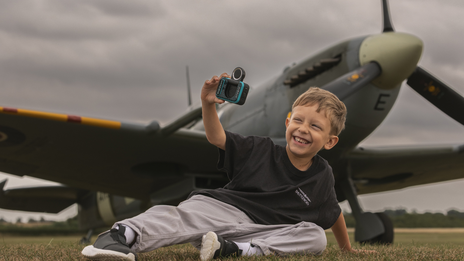 A Boy Sat Taking A Selfie In Front Of A Spitfire. © The Shuttleworth Trust. Photo Phil Chaplin