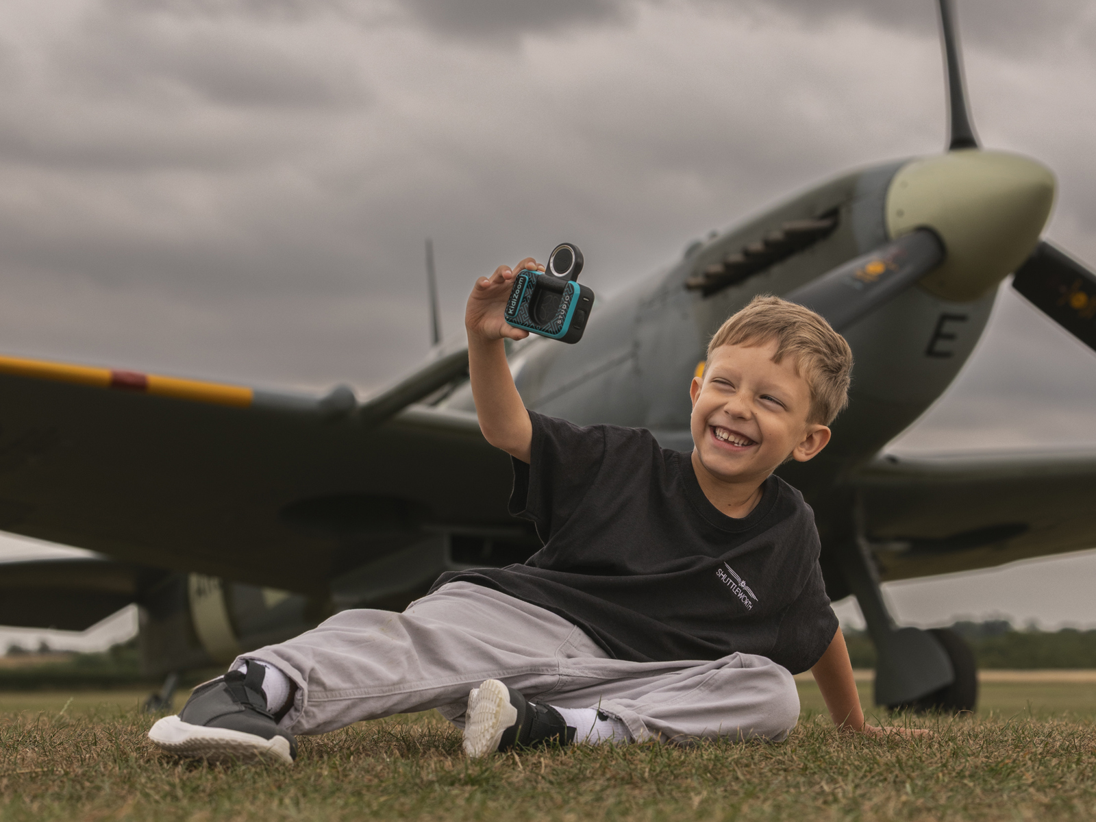 A Boy Sat Taking A Selfie In Front Of A Spitfire. © The Shuttleworth Trust. Photo Phil Chaplin